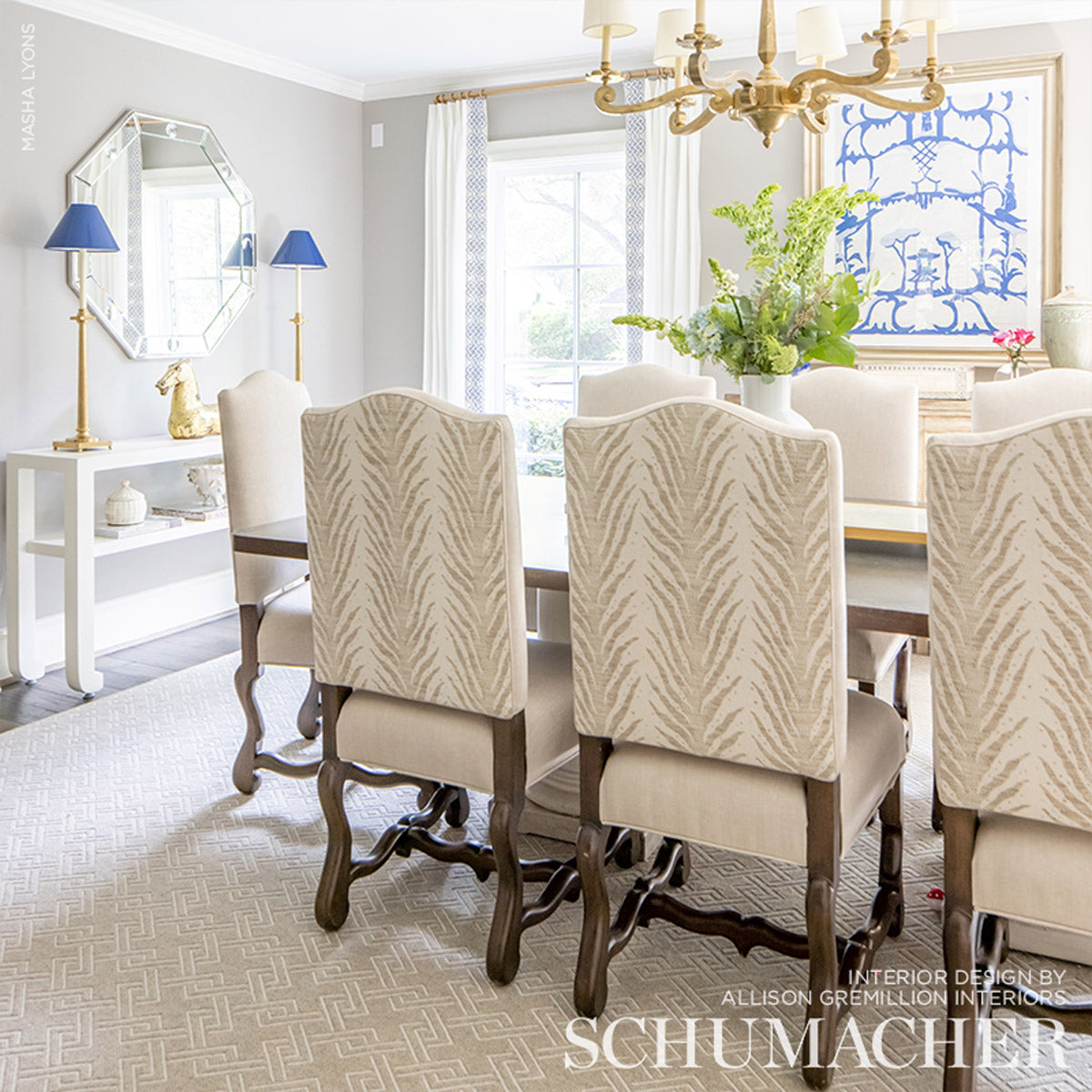 Beige woven upholstery fabric in a Creeping Fern pattern (Dune) used on chairs around a table.