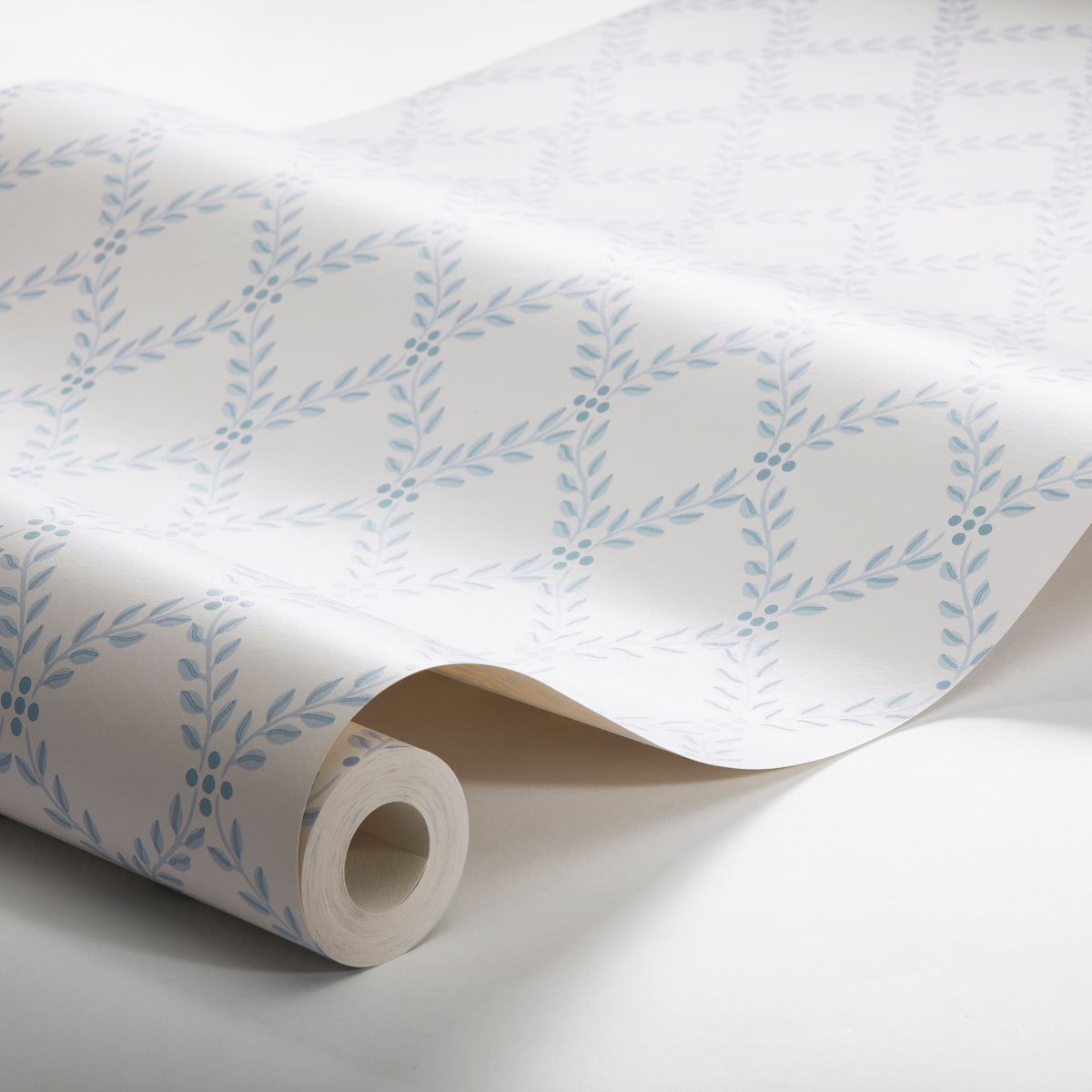 Rolled white wallpaper with pale blue laurel leaf pattern on diagonal vines; decorative botanical design.