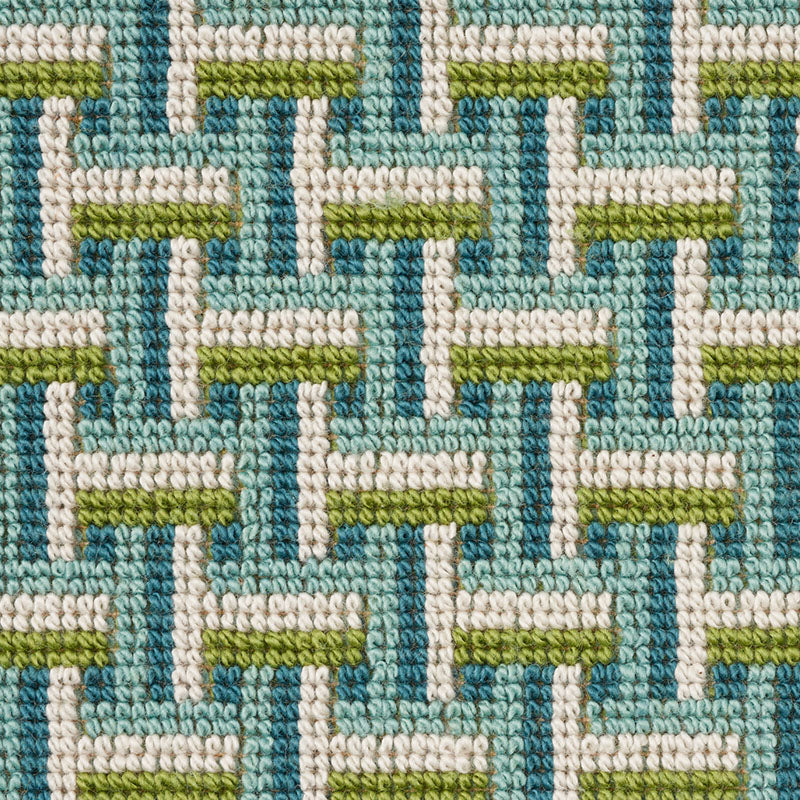Teal-green gradient woven textile with a colorful border; a soft decorative fabric item.