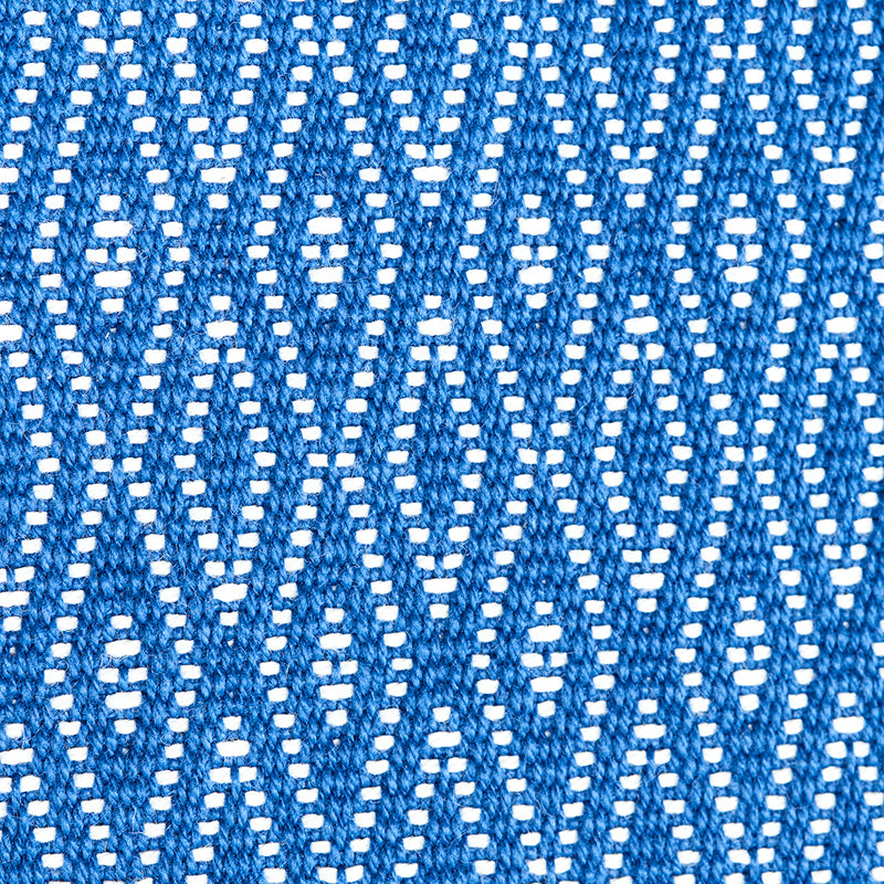 Blue woven fabric close-up with white dotted geometric pattern creating diamonds.