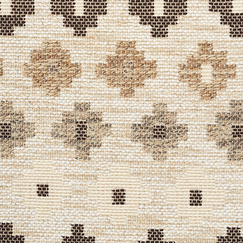 Neutral woven rug with cream base and tan-brown diamond motifs in a textured geometric pattern