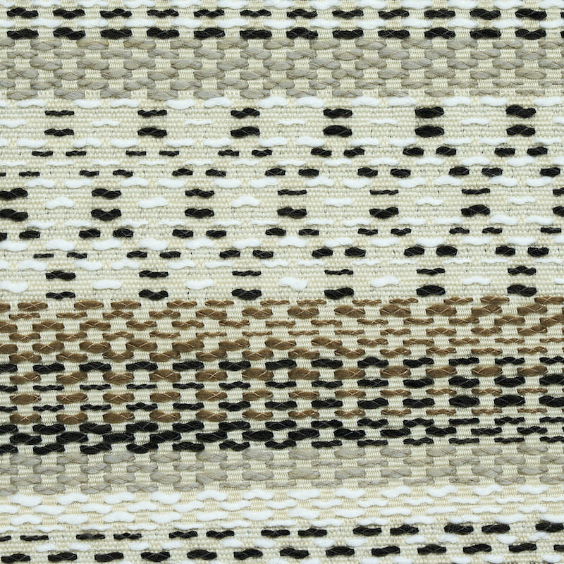 Handwoven jute rug with cream, tan and black dotted stripes in a geometric flat-weave design.