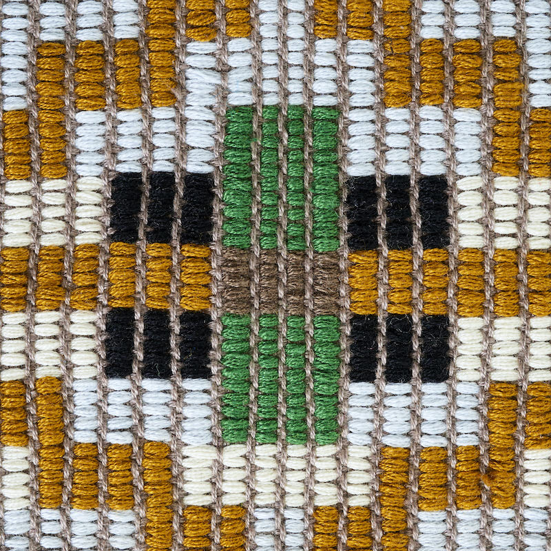 Close-up of woven textile with mustard yellow, white, black and green yarns in a geometric grid pattern.