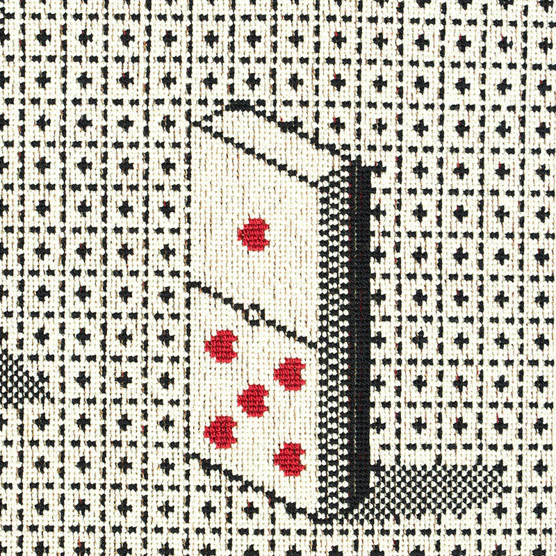 Black woven tapestry featuring a tilted domino tile with red pips on a grid pattern.