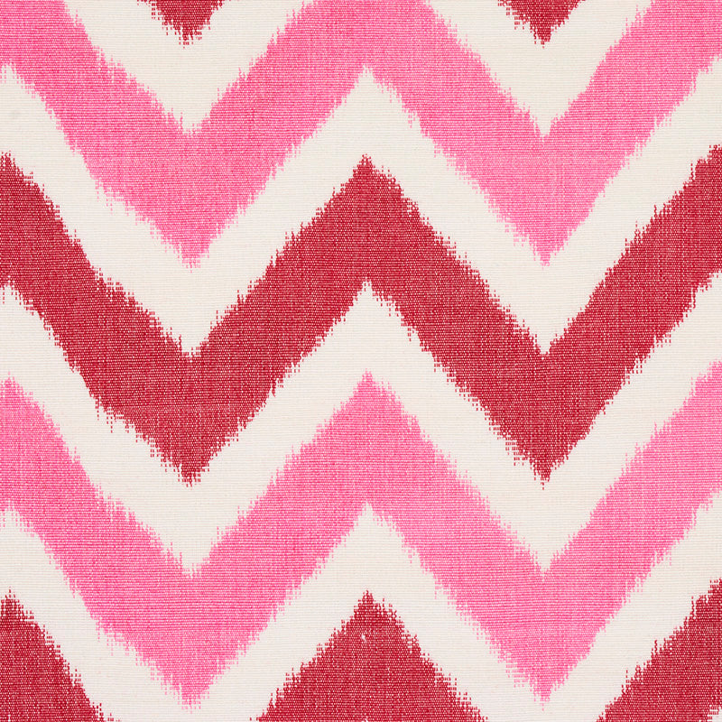 Chevron zigzag pattern in pinks and red on white, textured fabric.