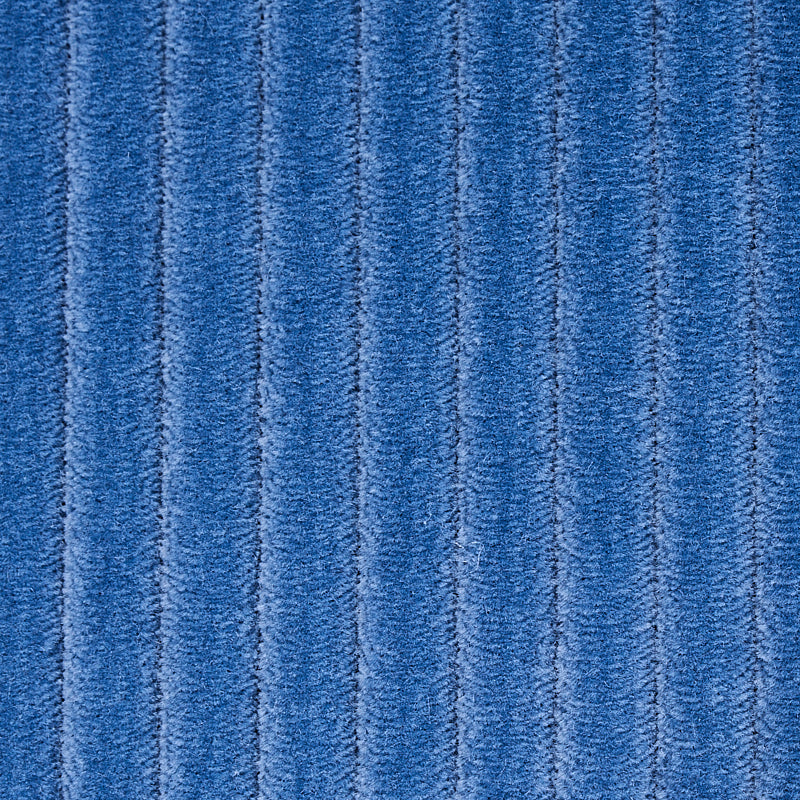 Blue ribbed fabric with vertical channels; plush upholstery or carpet texture.