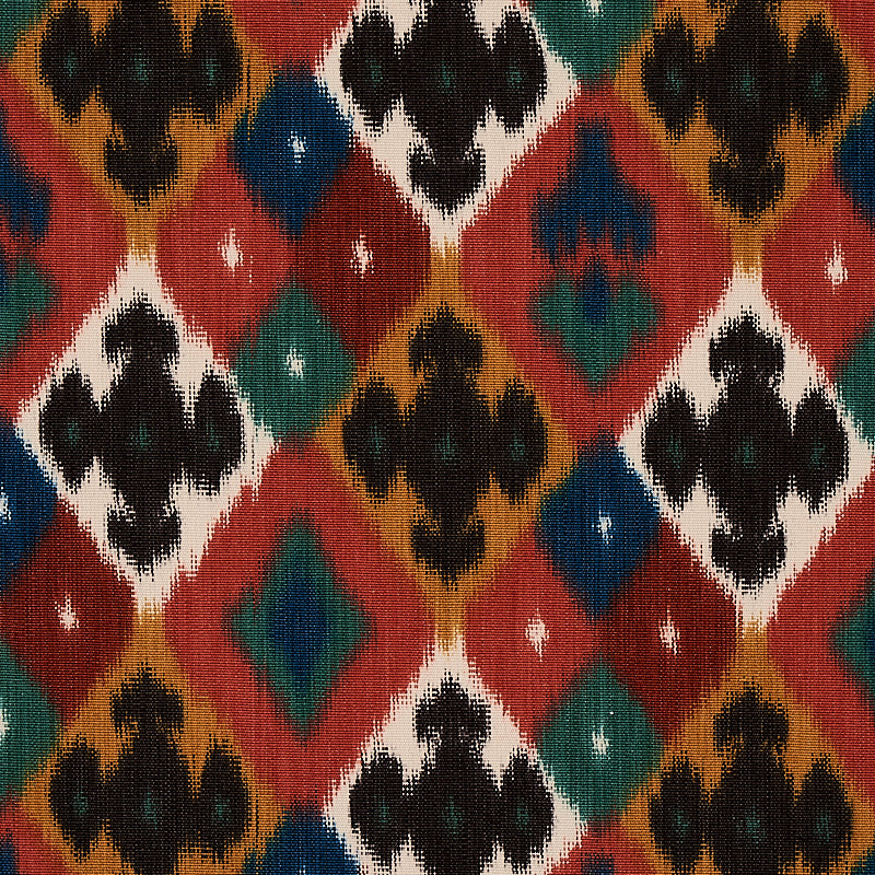 Colorful diamond ikat pattern textile with red, teal, black, white and mustard tones.