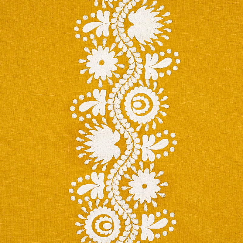 Mustard yellow fabric with white floral lace embroidery running vertically in a center stripe.