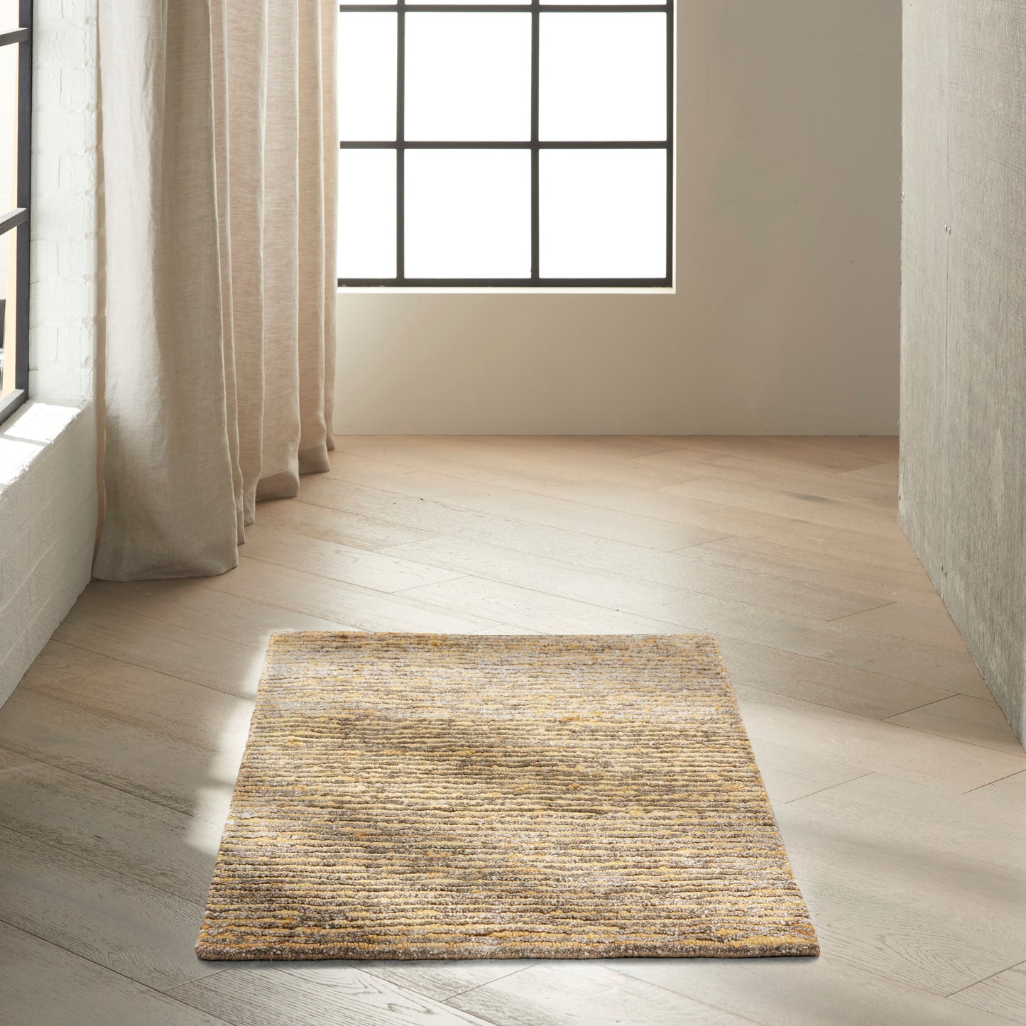 Rectangular natural beige woven jute rug with textured surface on light wood floor by a window.