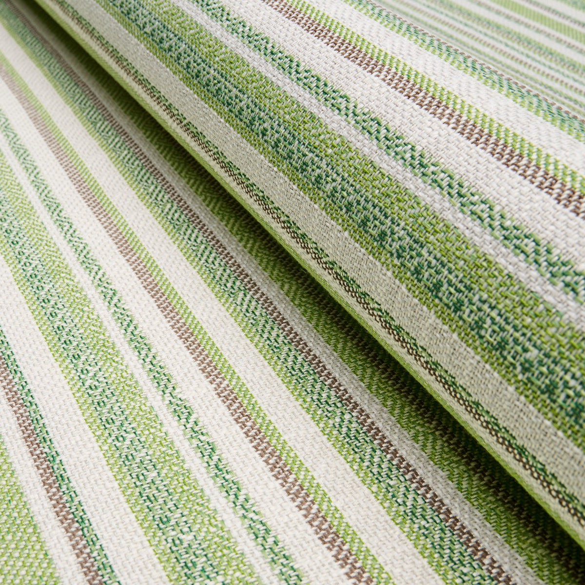Woven striped fabric in lime green, olive, beige and white with a textured pattern and folded layers.