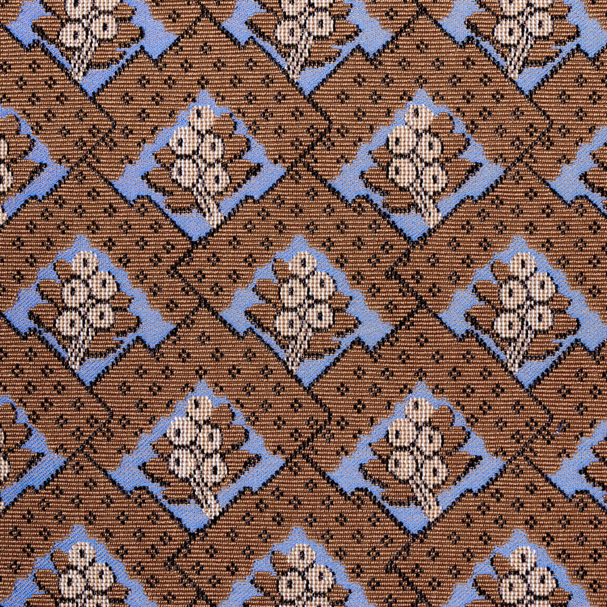 Brown fabric with blue diamond frames enclosing white floral bouquets in a repeating geometric pattern.