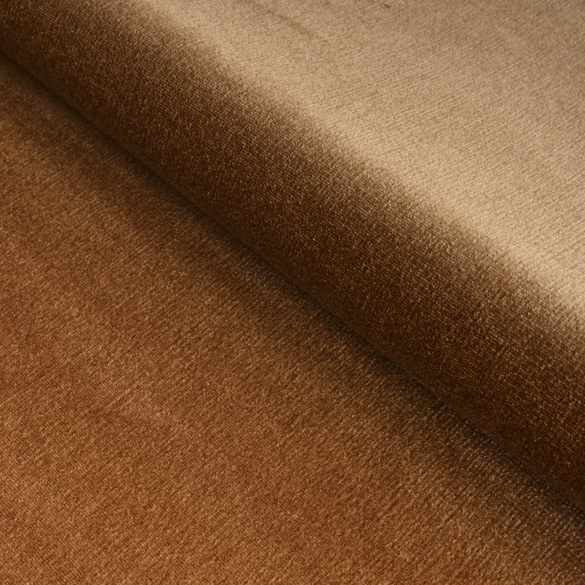 Close-up of warm brown wool fabric with a soft nap and a fold, versatile for clothing or upholstery.