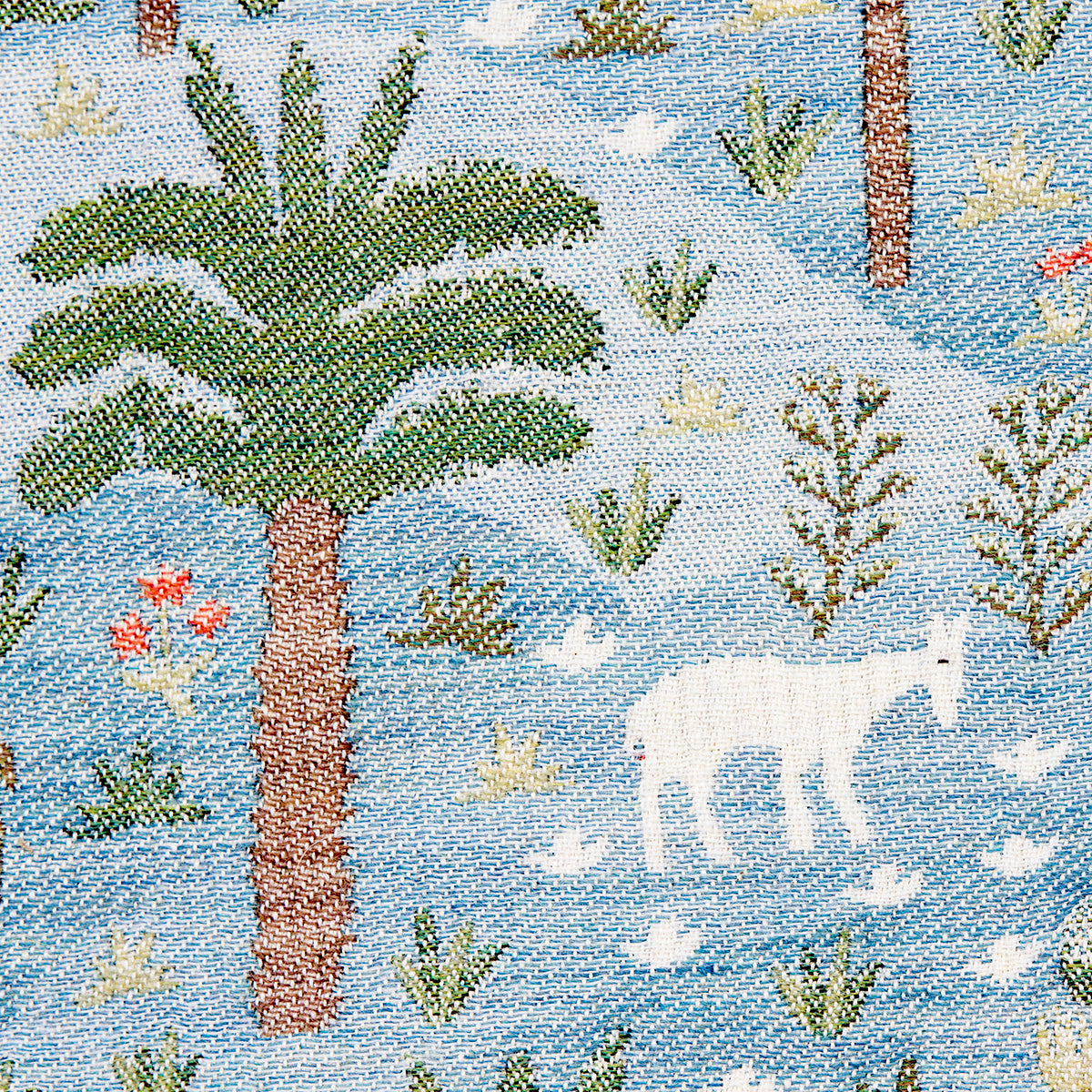 Tapestry fabric featuring palm tree & white horse silhouette, blue water background, green shrubs; decorative wall hanging.