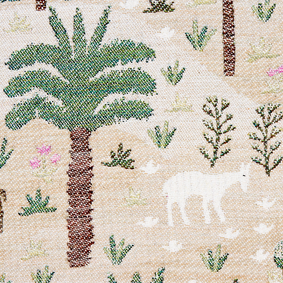 Beige woven tapestry with green palm trees, desert shrubs, and a white animal silhouette.