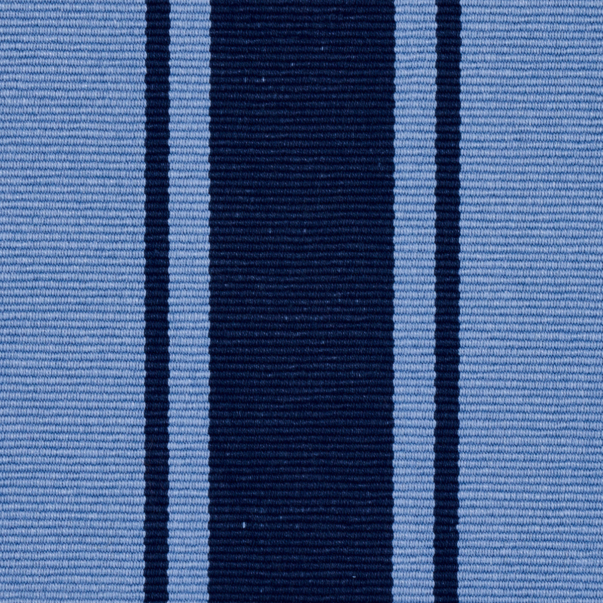 Close-up of blue striped woven fabric with a wide navy center stripe and lighter blue side stripes.