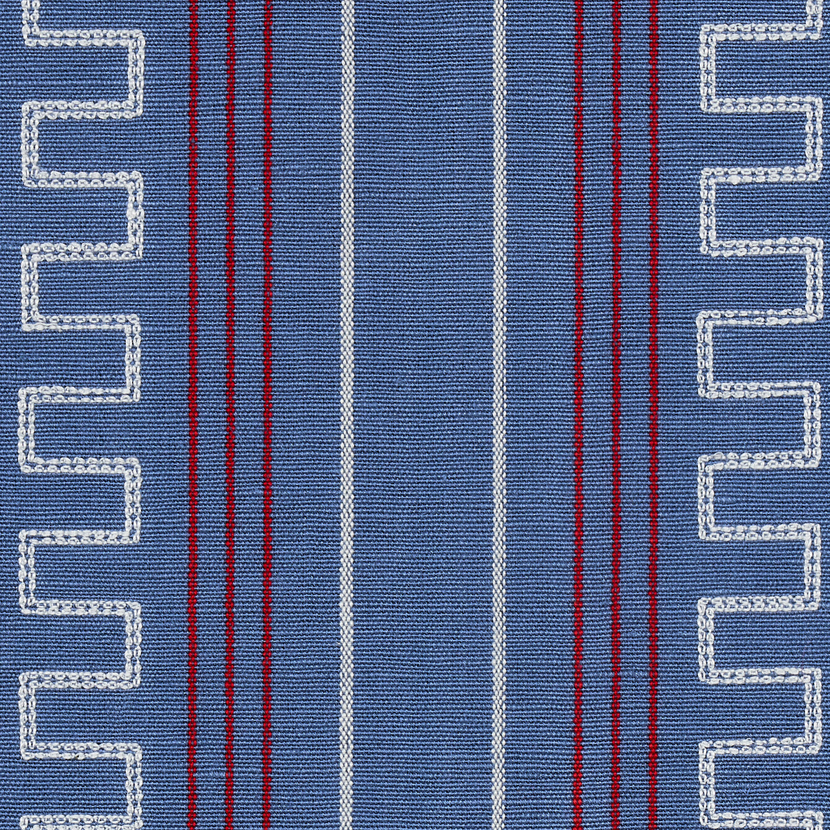 Blue woven fabric with white zigzag borders along edges and central vertical white and red stripes.