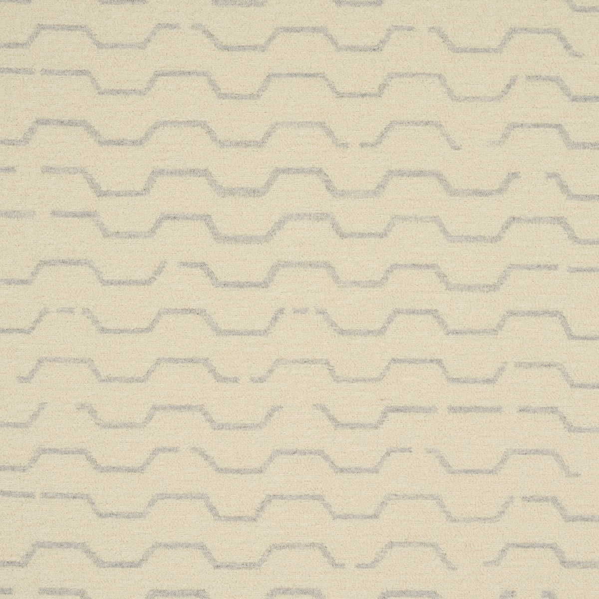 Beige textured fabric with pale gray stepped zigzag pattern in horizontal rows.