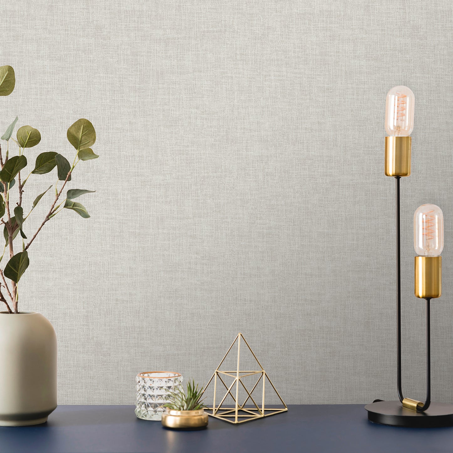 Beige wallpaper with linen-weave texture, Antibes pattern, covering a wall.