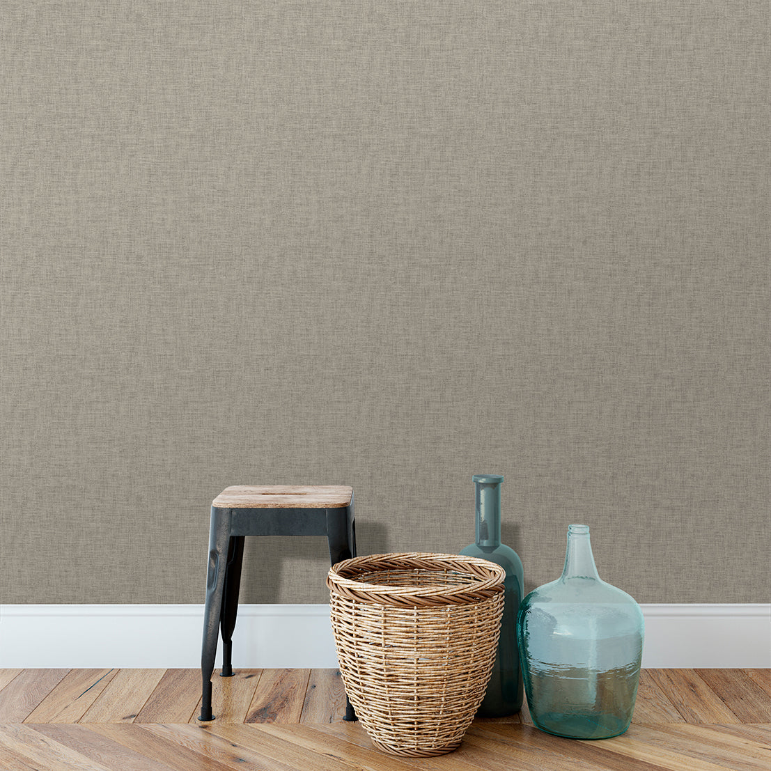 Beige tan linen-weave textured wallpaper on a wall in a neutral room with a wooden floor.