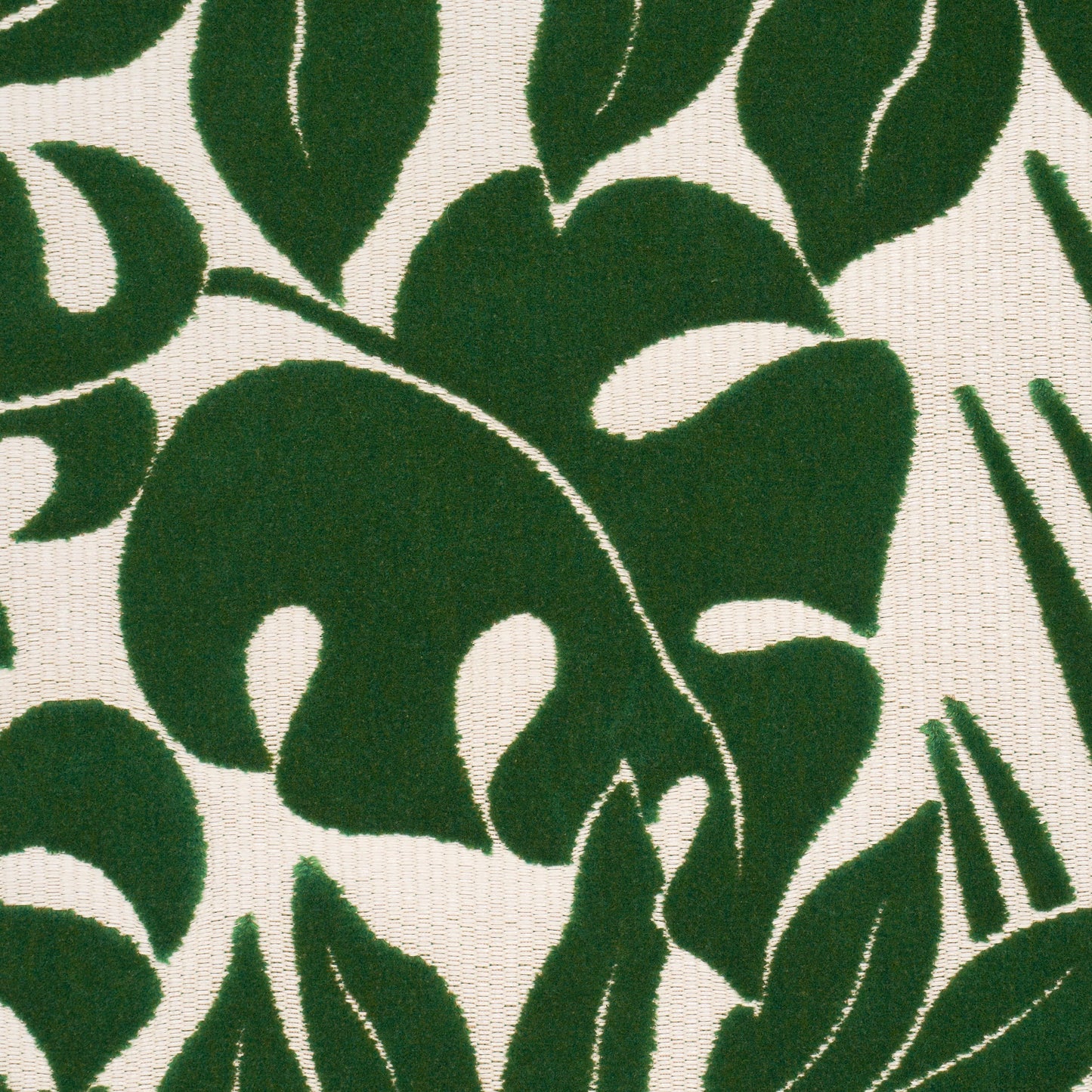 Close-up of dark green tropical leaf pattern on beige woven fabric; botanical textile design.