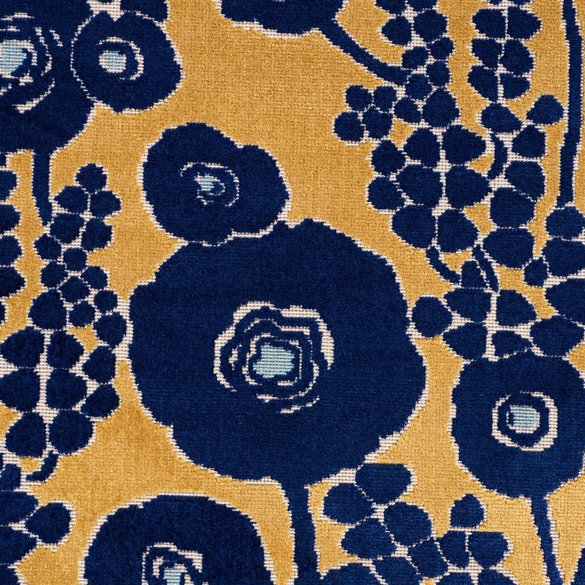 Navy blue large circular floral motifs on mustard yellow background with light blue centers and grape-like berry clusters; woven rug.