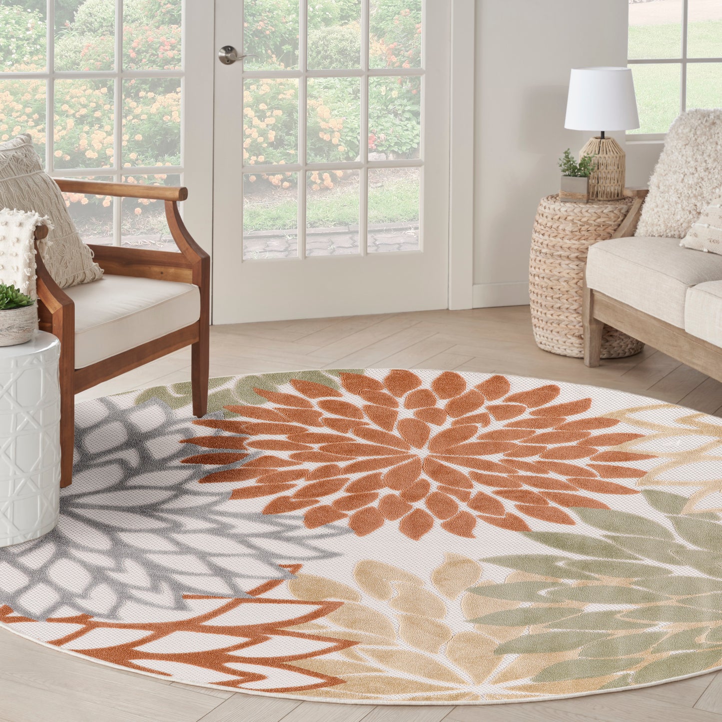 Round floral outdoor rug, 5' diameter, with orange, gray and sage petals on an ivory background.