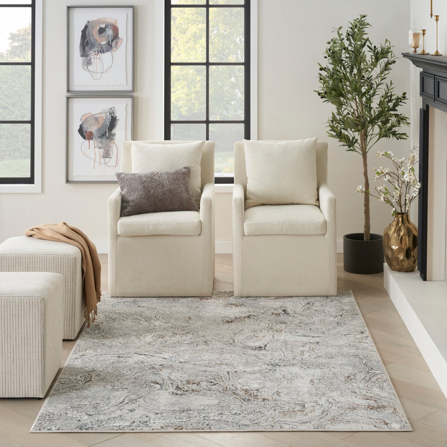 Modern rug with a gray abstract pattern in a bright neutral living room, 5' x 7', with a tall plant visible.