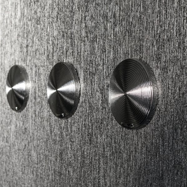 Close-up of dark textured wallpaper with a subtle metallic silver-grey finish.
