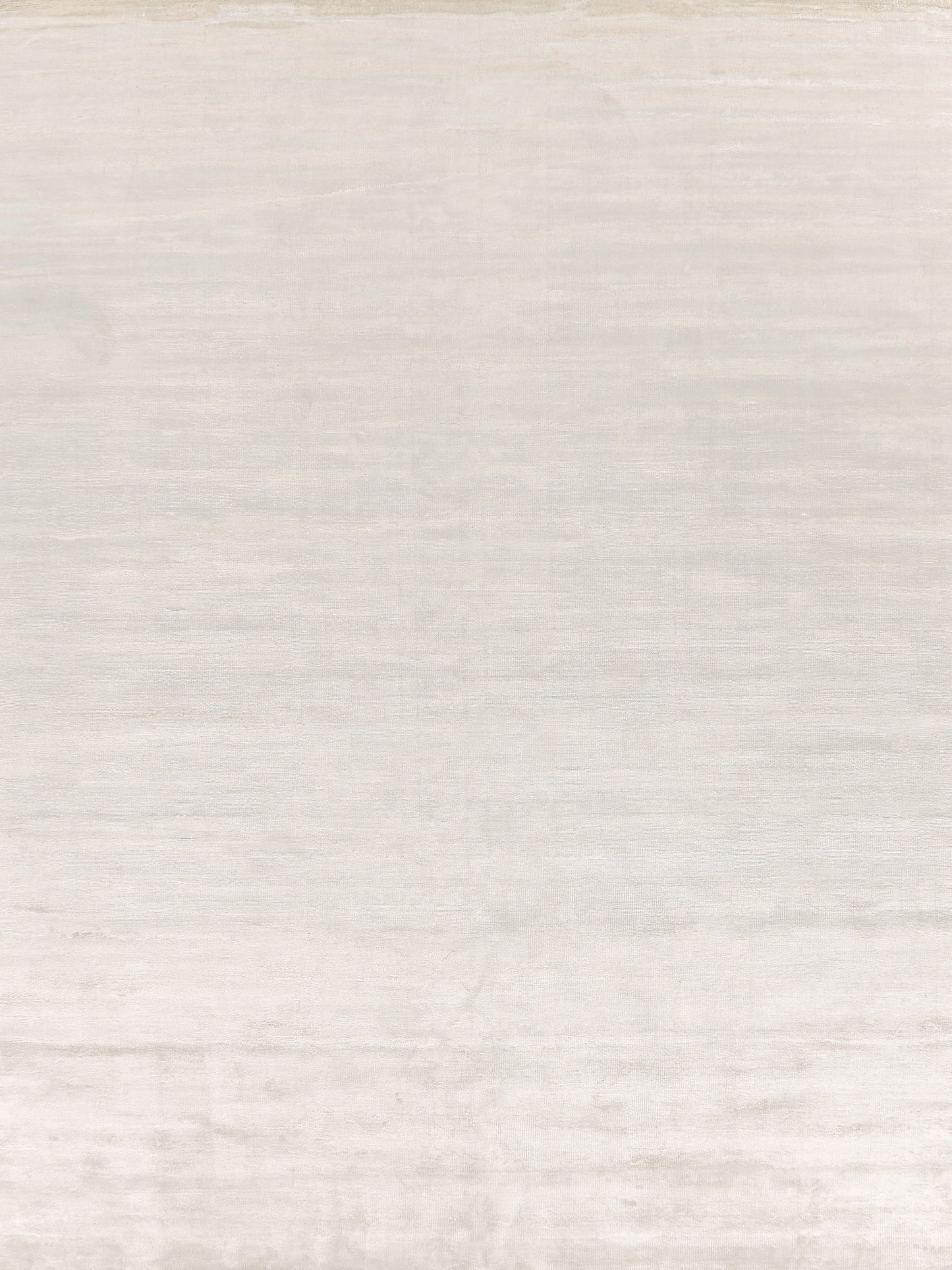 Light beige handwoven rug with a soft texture and subtle sheen; rectangular 4' x 6'.