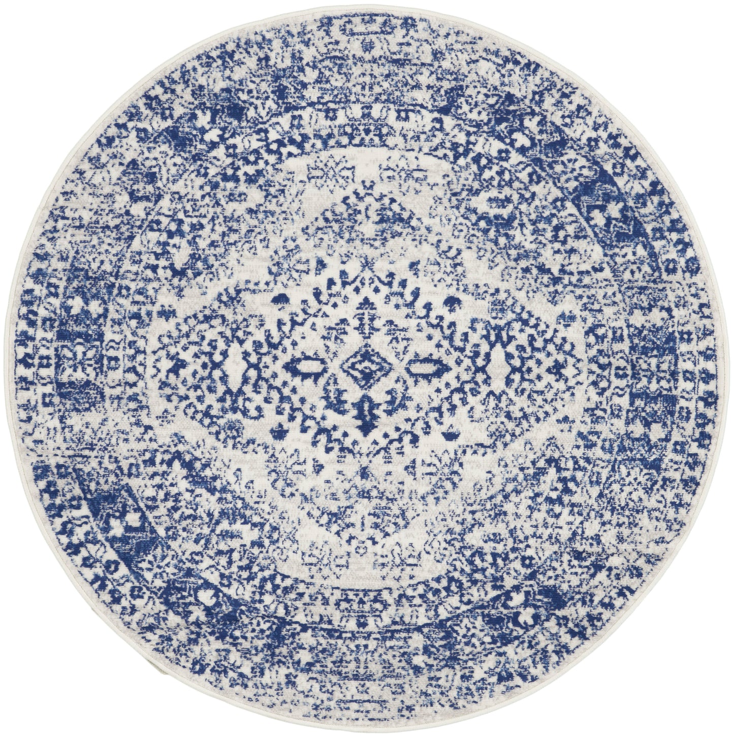 Round blue and white distressed rug with an oriental medallion pattern and intricate detailing.