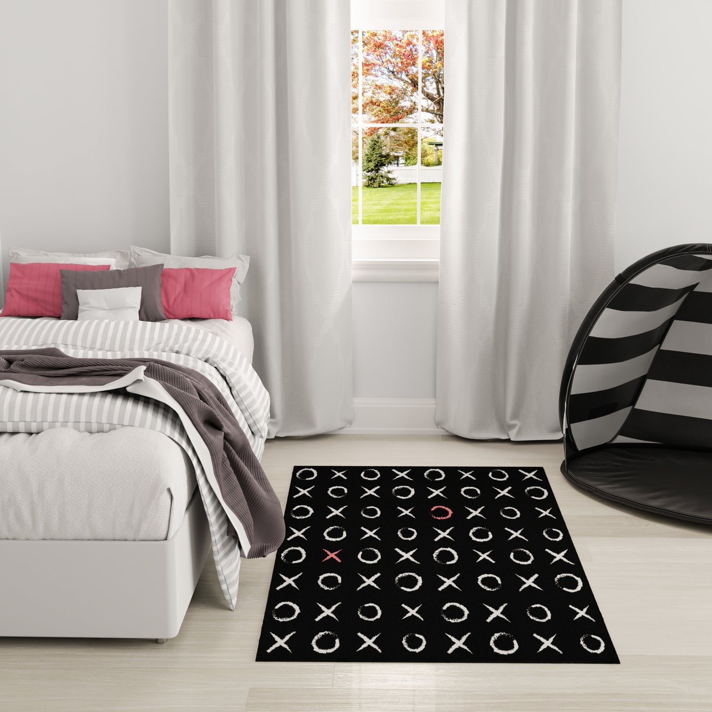 Bedroom with white-gray bedding, pink pillows, black XOXO rug, light wood floor, and striped hanging chair by the window.