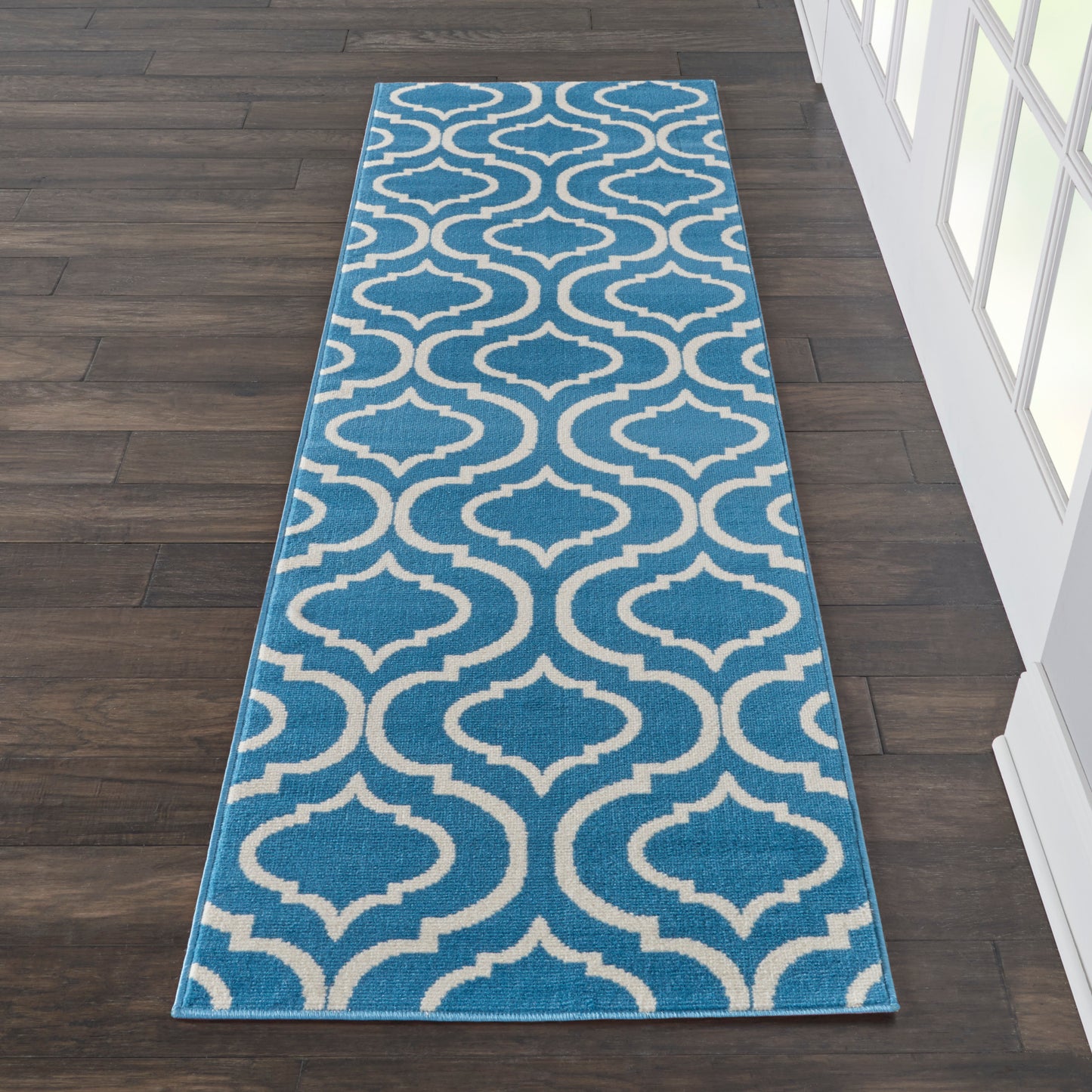 Blue runner rug with cream trellis pattern; long, narrow hallway/entryway rug.
