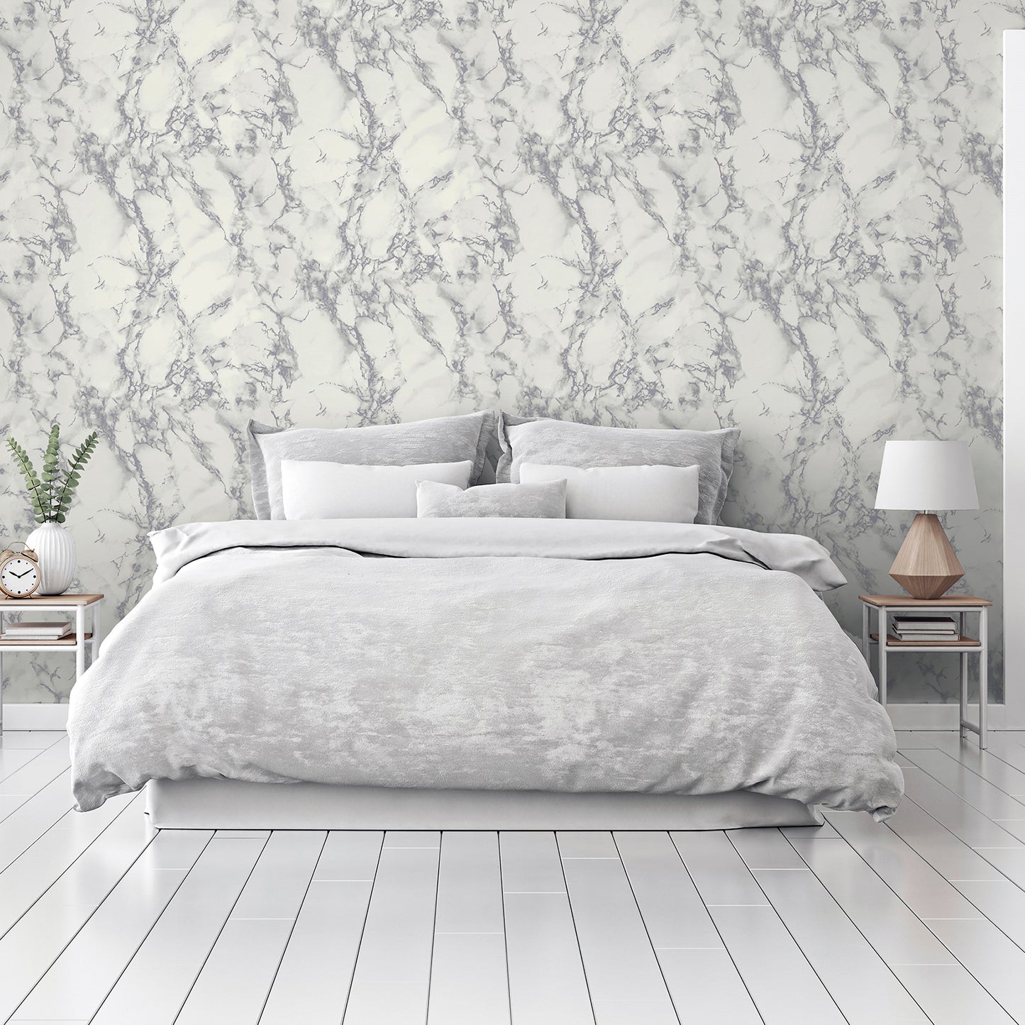 Grey & white metallic marble wallpaper on the wall behind a bedroom setup with soft gray bedding.