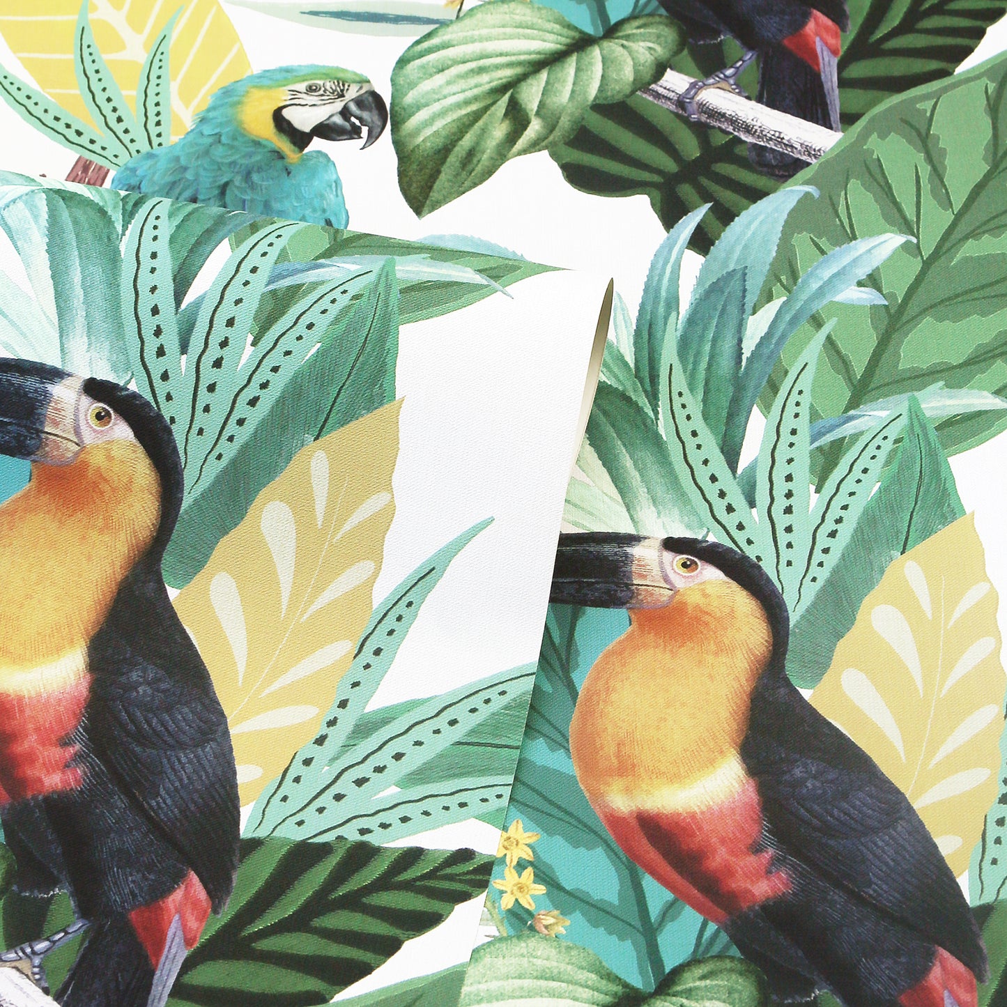 Bright tropical print with toucans among large green and teal leaves, yellow accents; bold jungle foliage design.