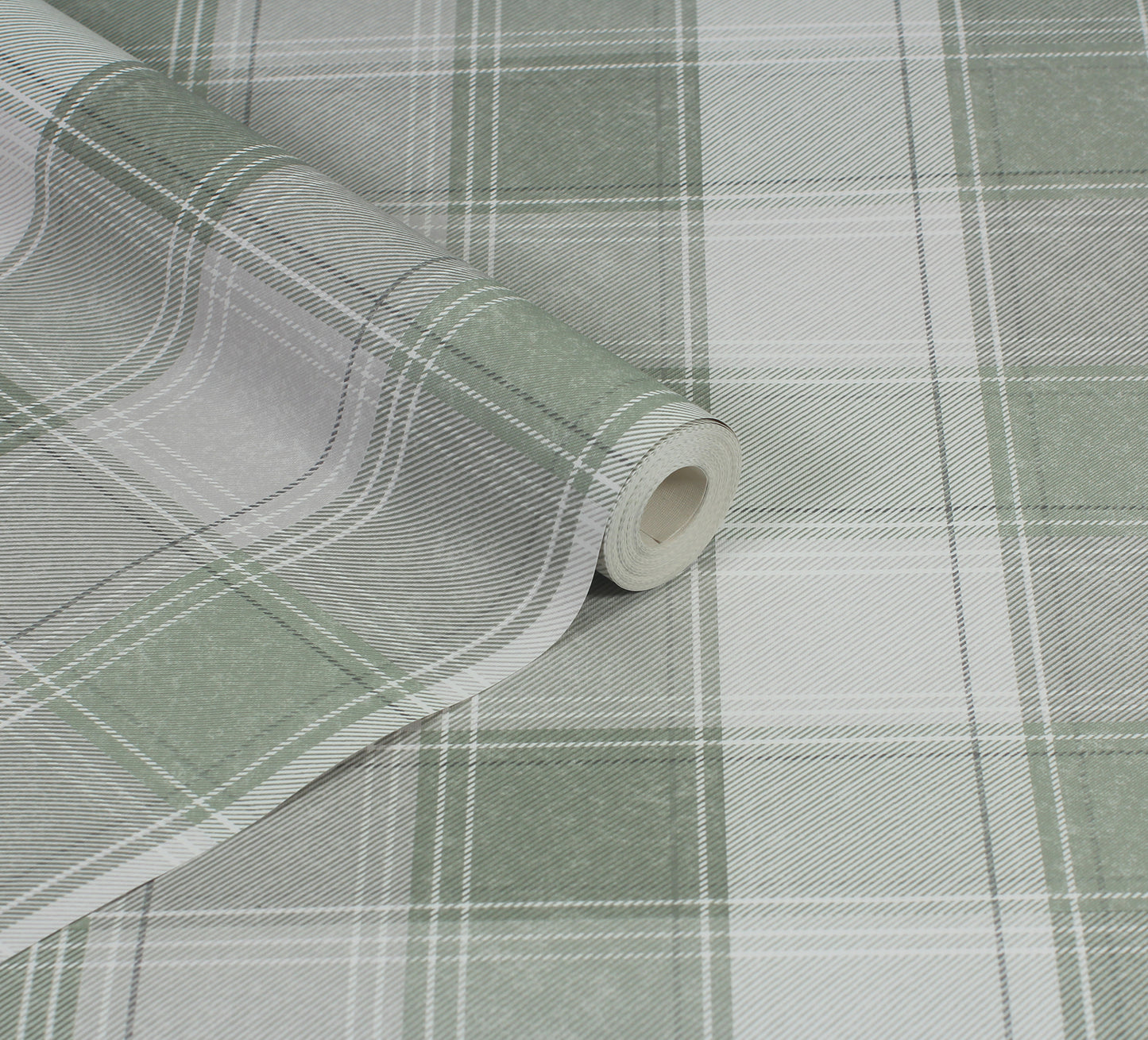 Close-up of green and white plaid fabric roll with folded edge; checkered textile for upholstery or crafts.