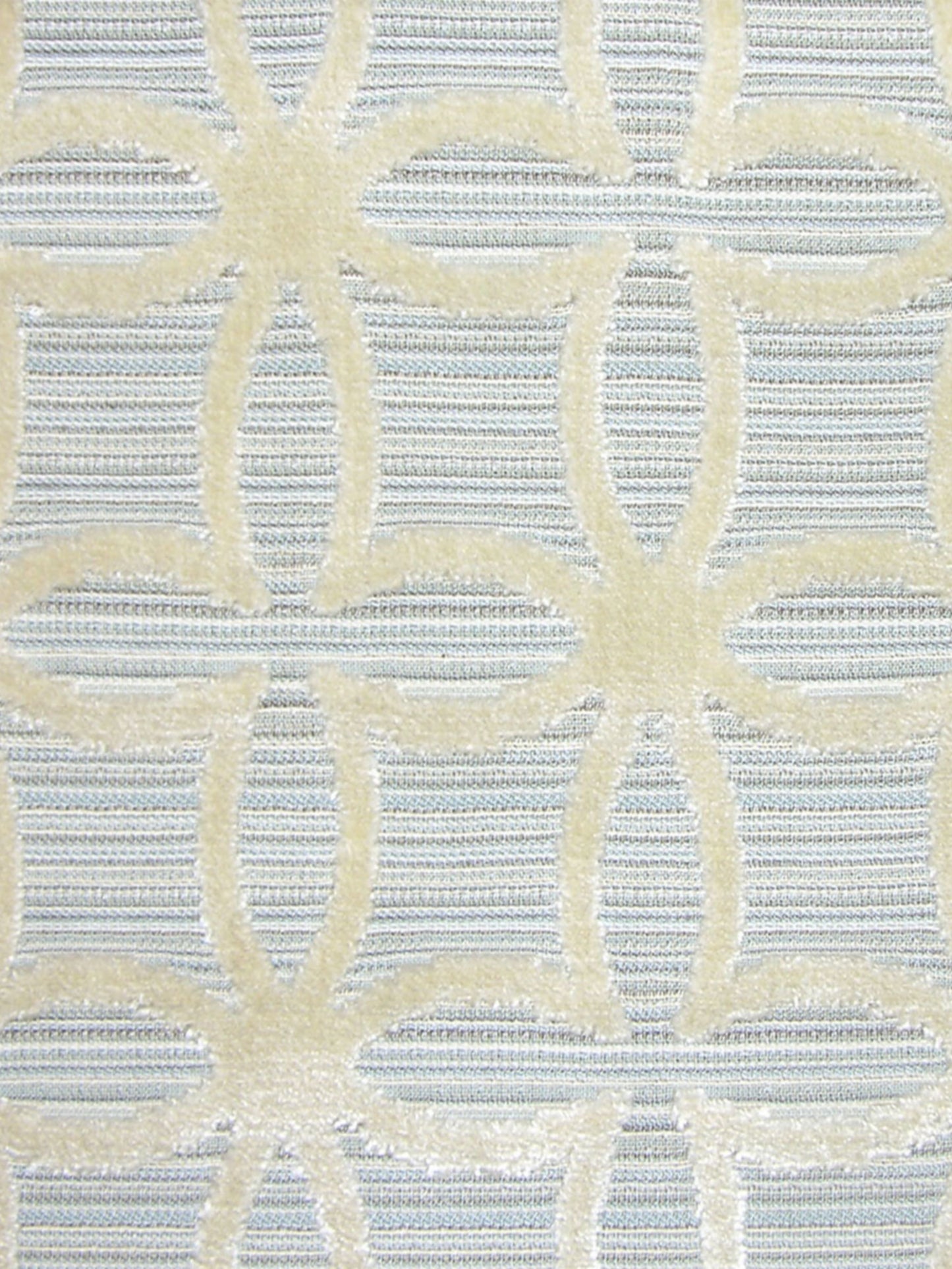 Light blue woven fabric with pale yellow interlocking circular lattice pattern; damask-style upholstery or drapery textile.