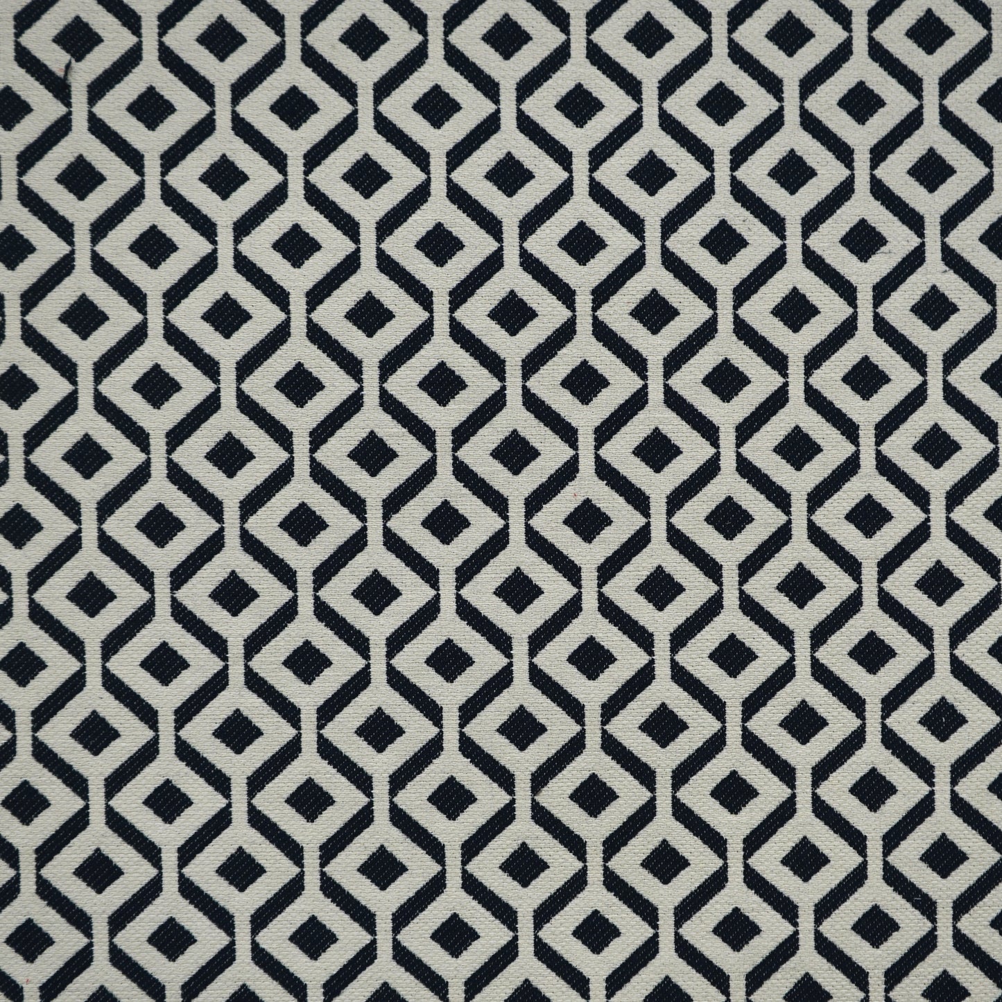 Navy and beige geometric diamond lattice on woven Jacquard fabric; modern upholstery and home-decor textile.