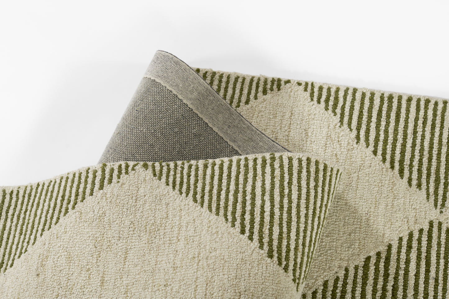 Beige woven rug with olive-green chevron triangles; geometric pattern, soft texture, versatile for living spaces.