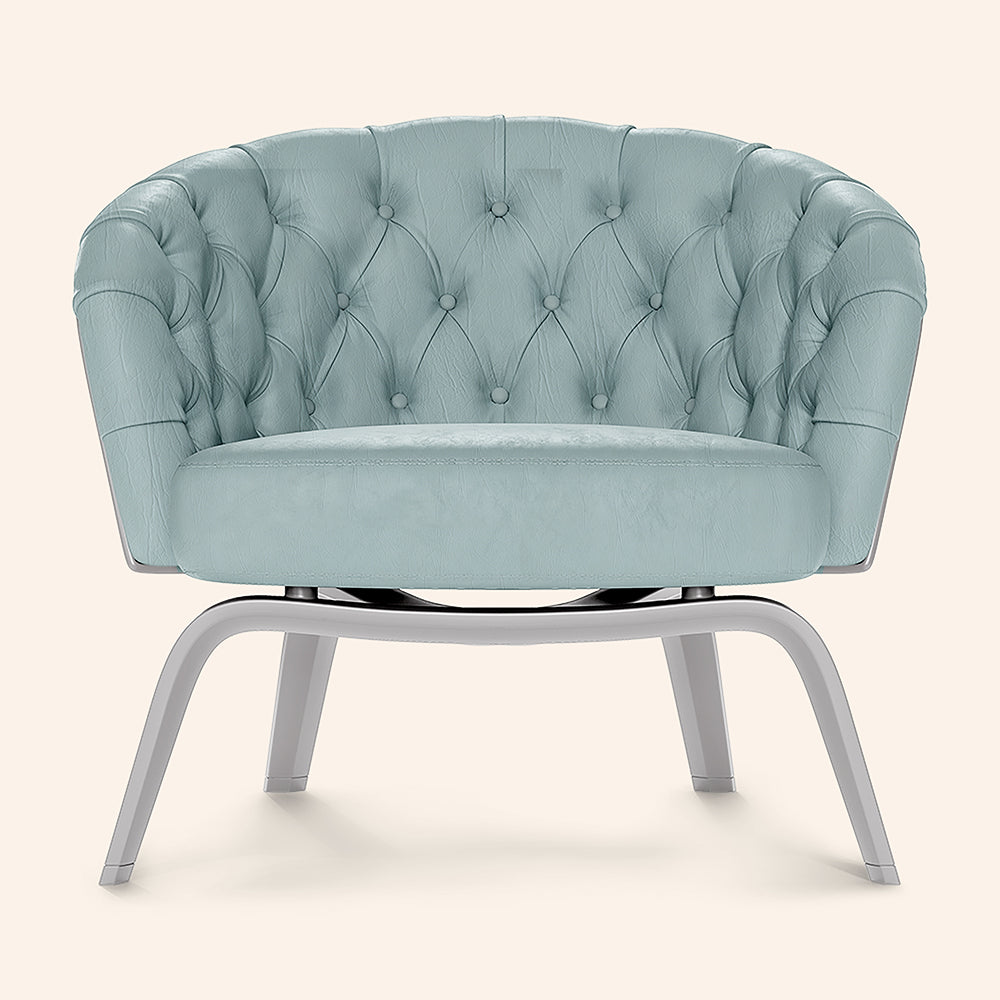 Light blue velvet round tufted lounge chair with curved arms and silver metal pedestal legs.