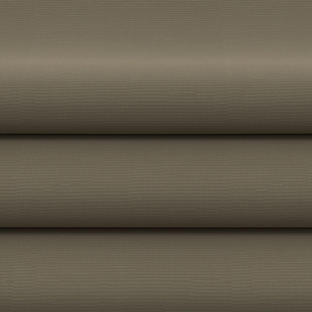 Beige solid upholstery fabric displayed in flatlay with rolled layers.