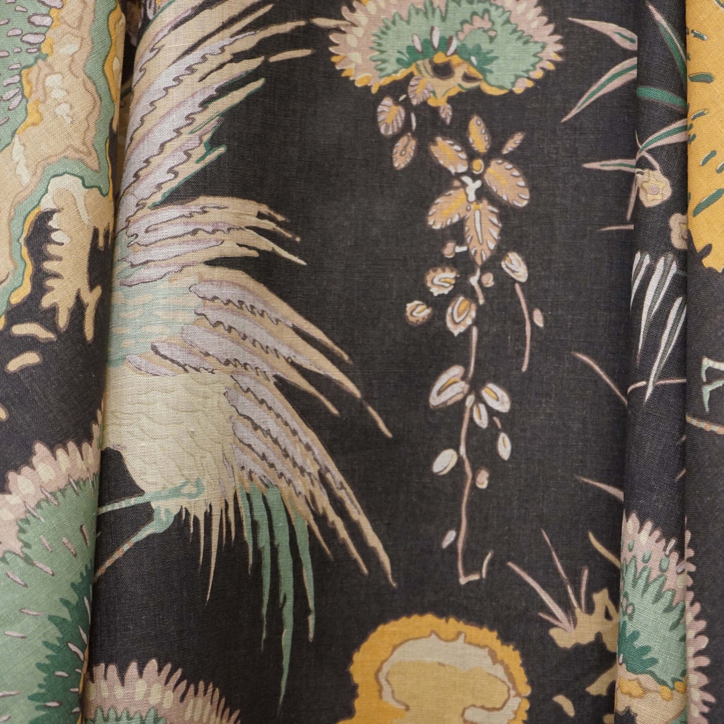 Black toile linen fabric with animal-print motif in brown and mustard.