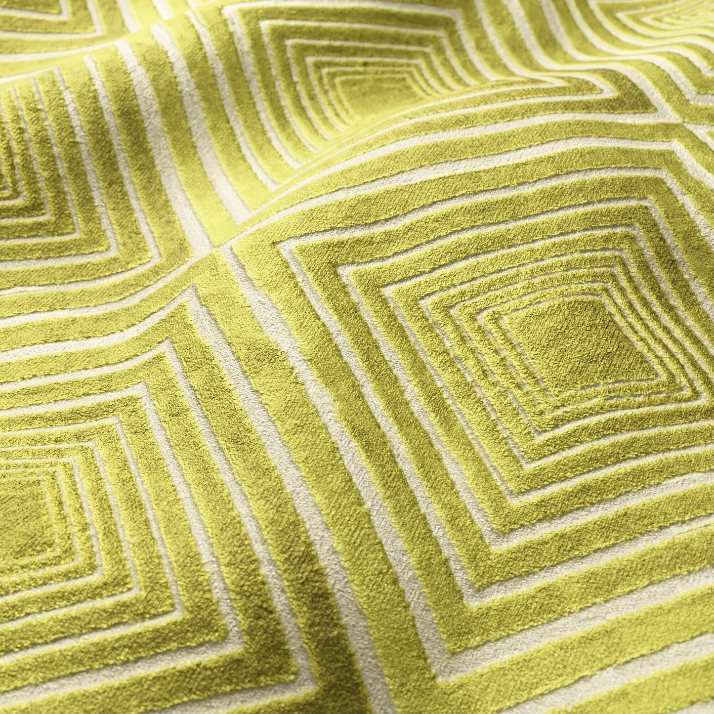 Green velvet fabric with a geometric diamond pattern.