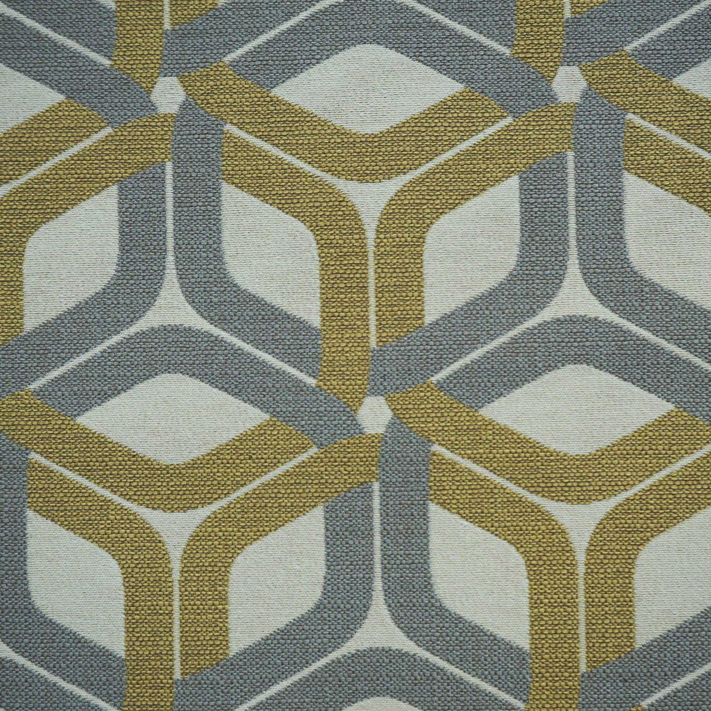 Geometric interlocking chevron pattern on pale beige fabric in gray-blue and mustard.