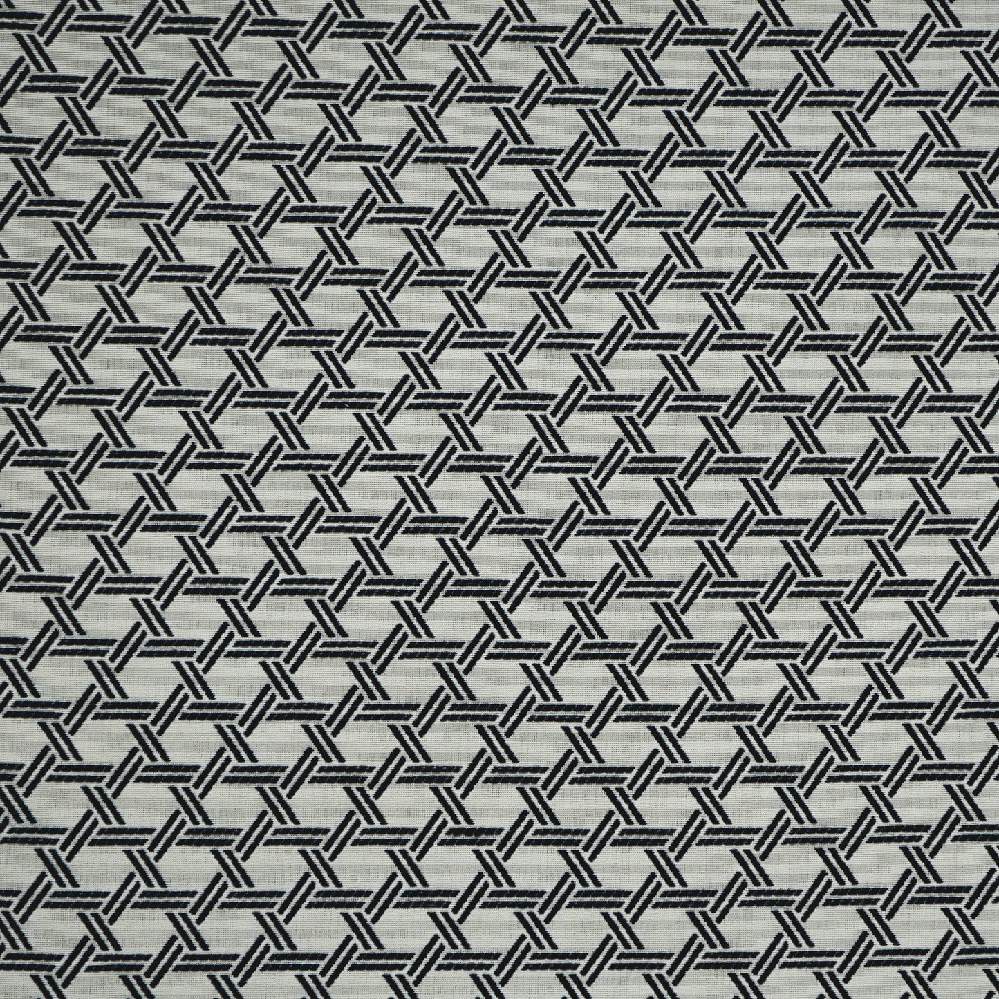 Blue geometric jacquard fabric with an interlocking hex motif and a tight basket-weave texture.