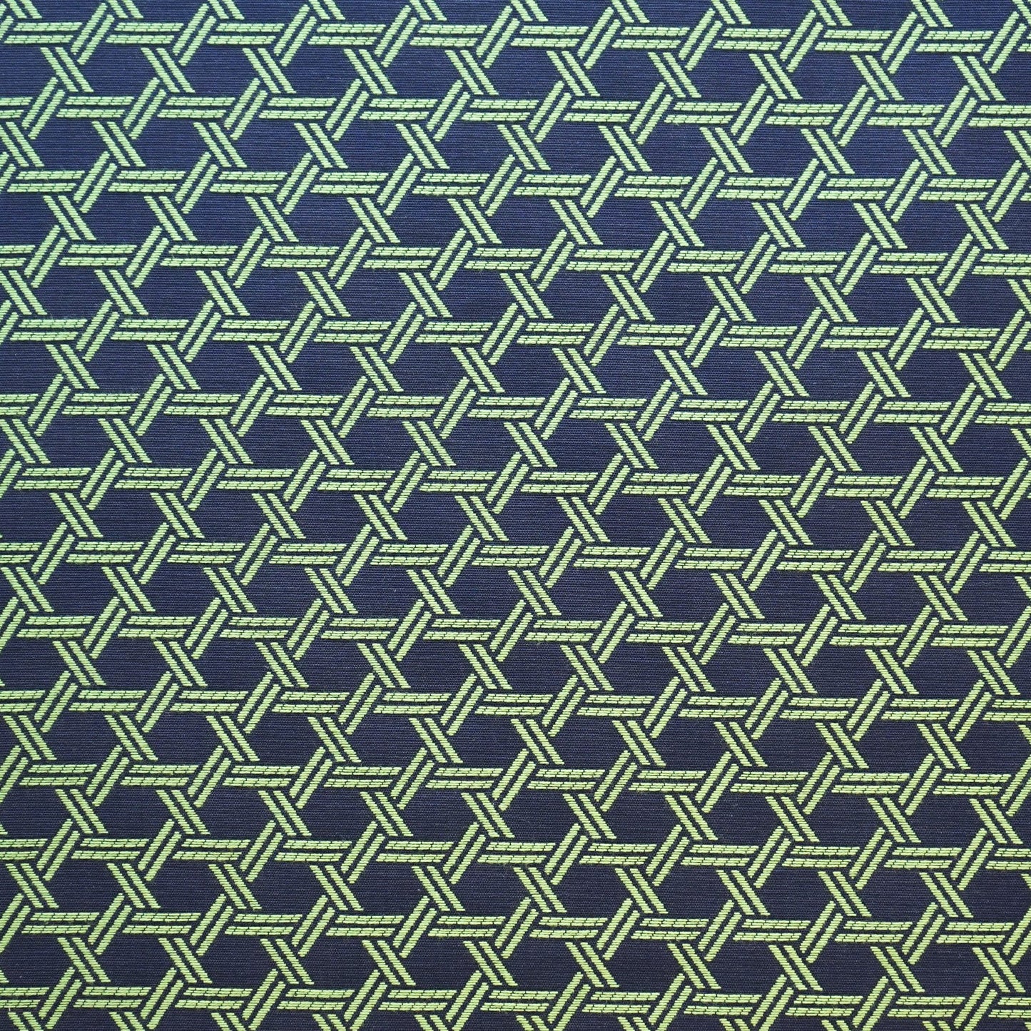 Blue jacquard fabric with an interlocking geometric lattice pattern; woven texture.