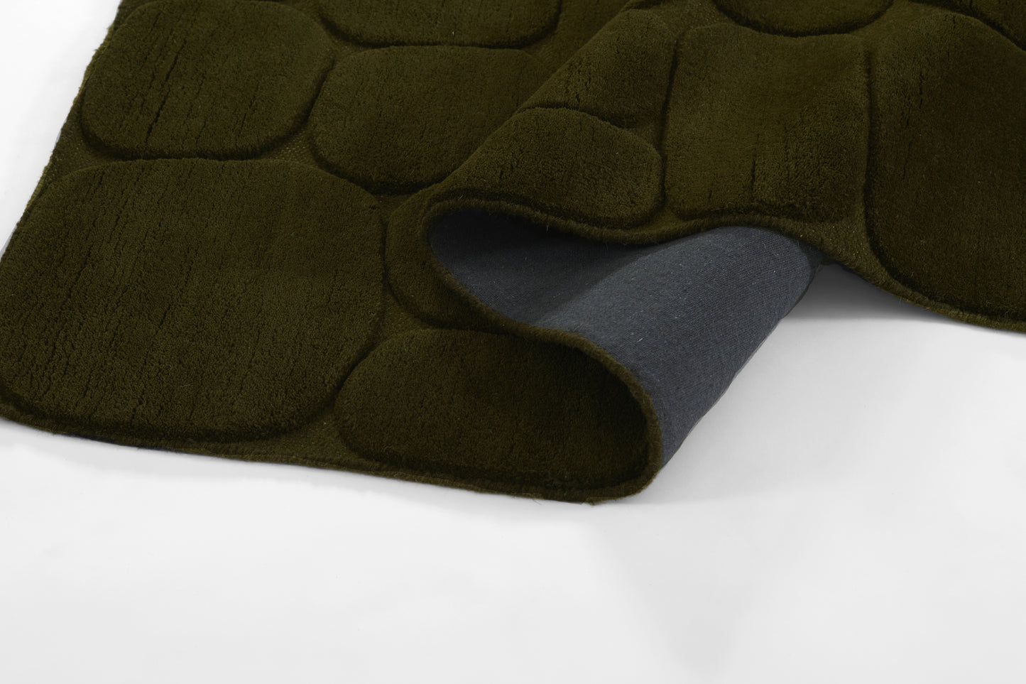 Olive-green plush rug with bubble-quilt texture; blue underside peeks out.