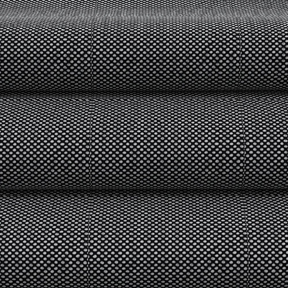 Black perforated fabric on rolled bolts; versatile upholstery or apparel textile.