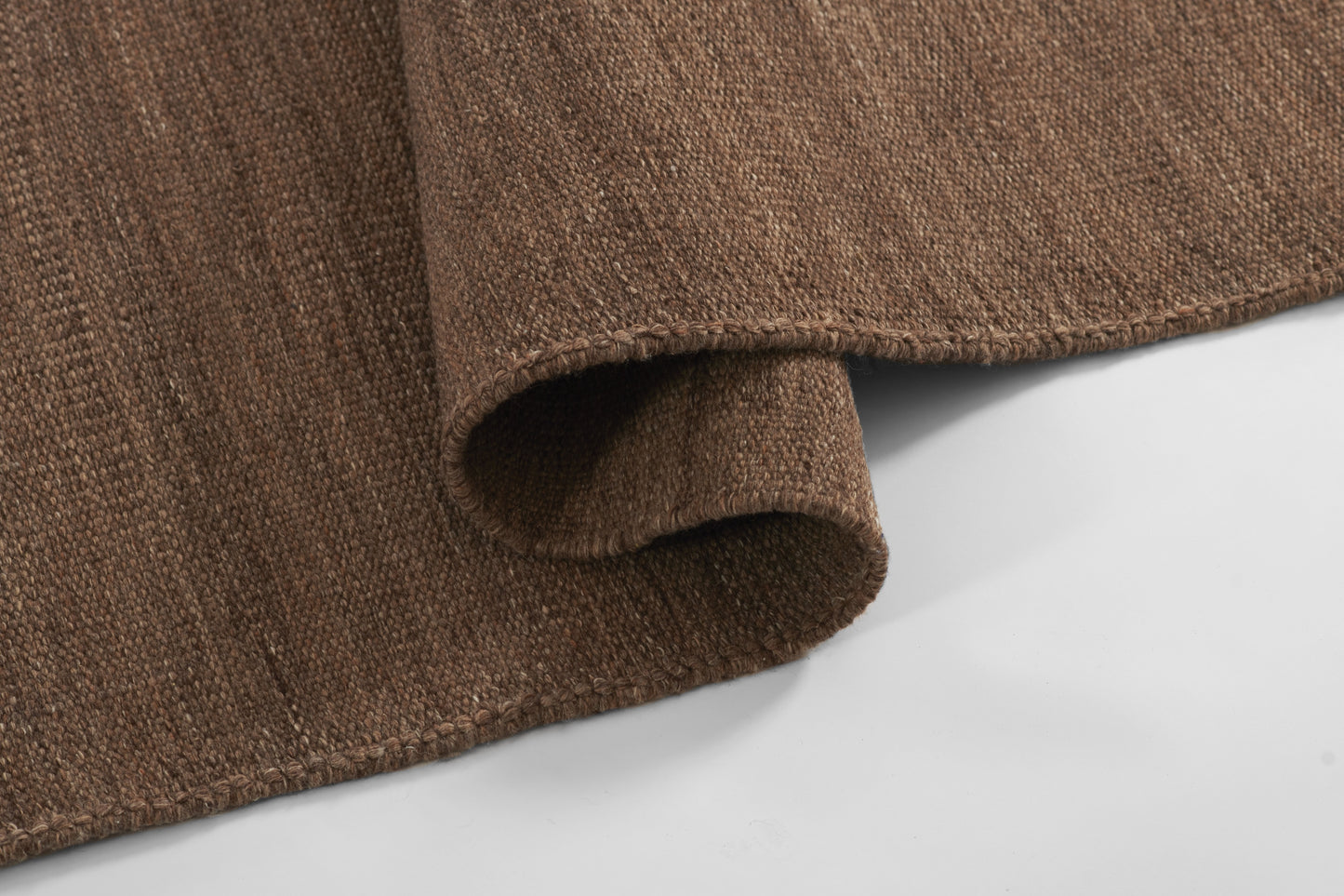 Brown textured rug with rolled edge in cocoa brown, 2' x 3' area rug.