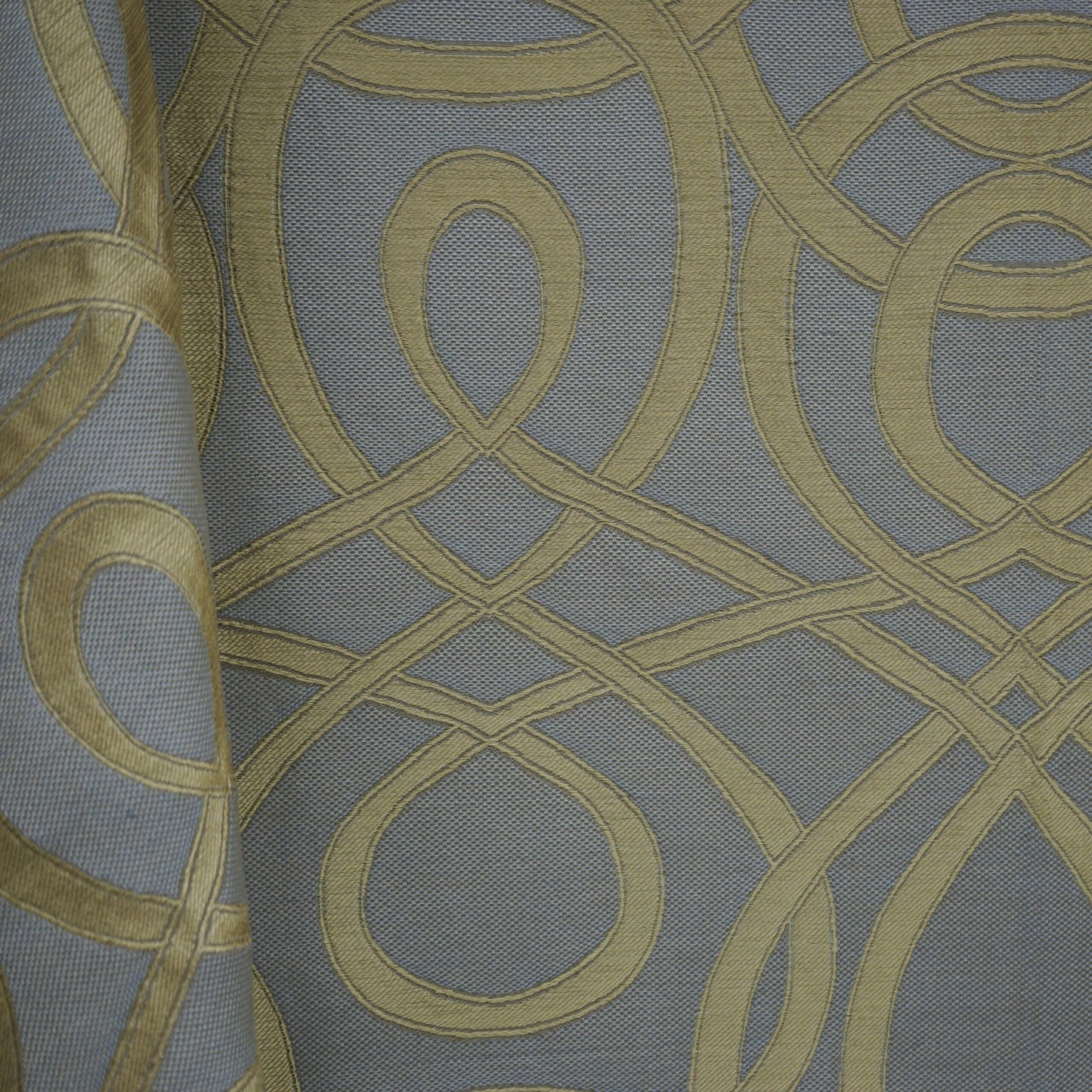 Grey-blue upholstery fabric with gold looping scroll pattern; jacquard weave, decorative for furniture or drapery.
