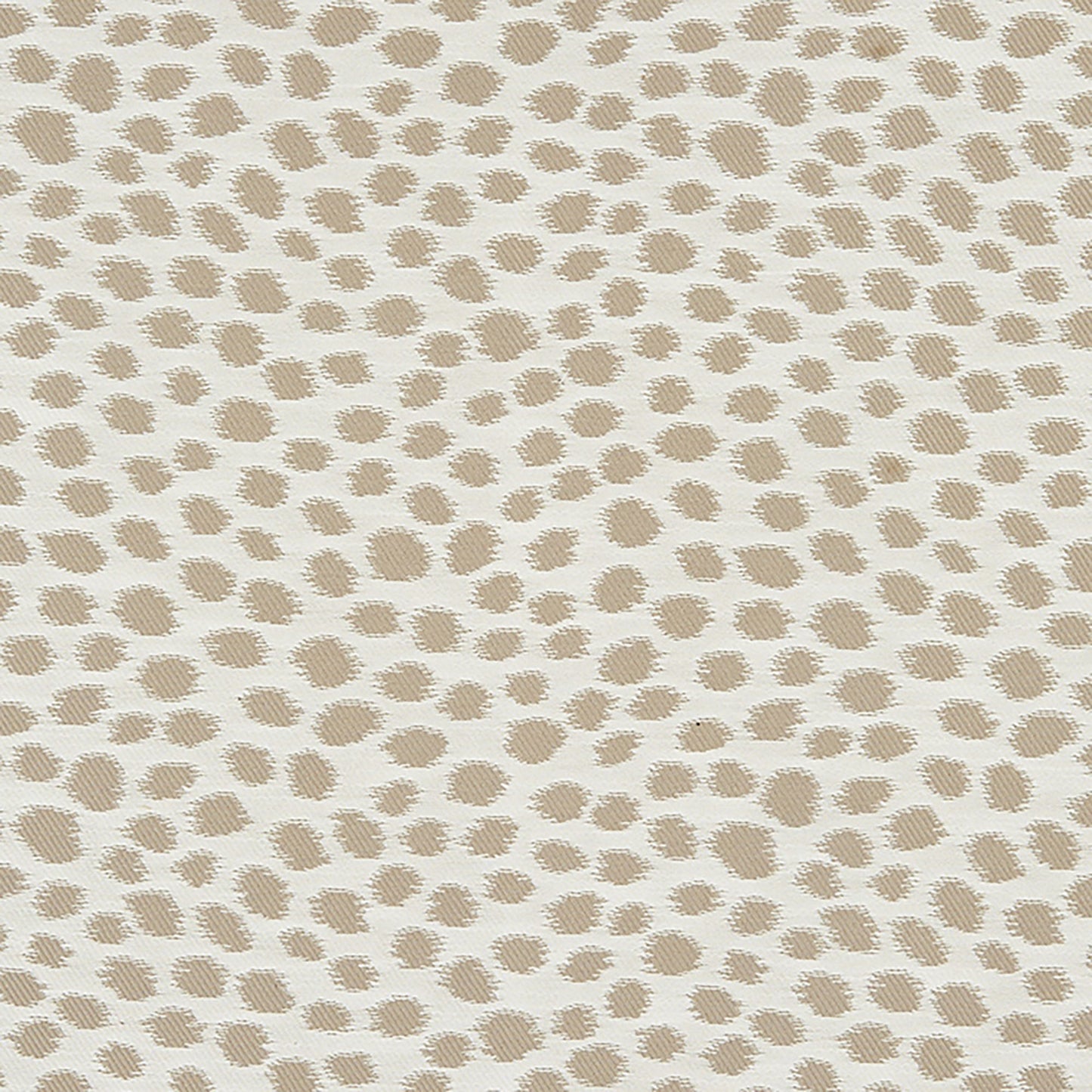 Beige Dalmatian-dot fabric on cream background; textured upholstery textile for cushions or drapes.